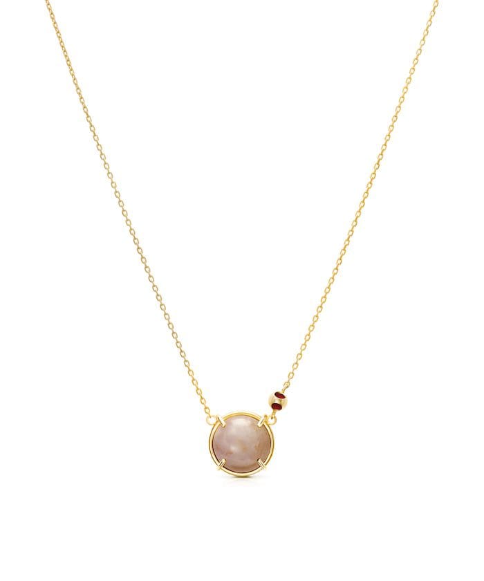Elegant gold chain with a tiny moonstone pendant and bead accents, perfect for sophisticated jewelry lovers.