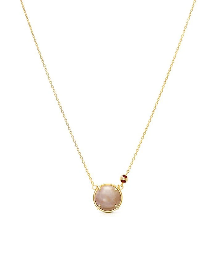 Elegant gold chain with a tiny moonstone pendant and bead accents, perfect for sophisticated jewelry lovers.