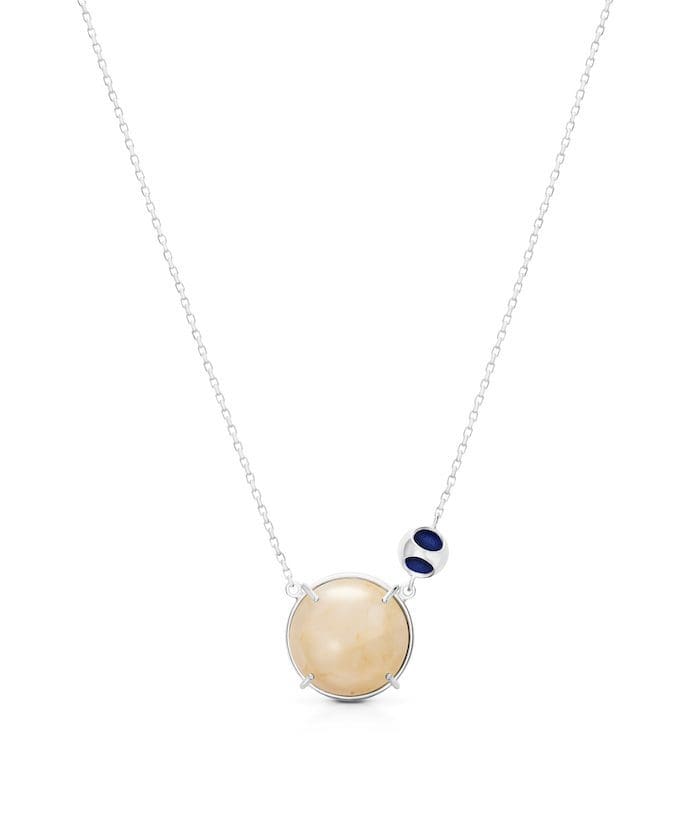 Elegant moonstone pendant with navy accents, sterling silver chain for a sophisticated look.