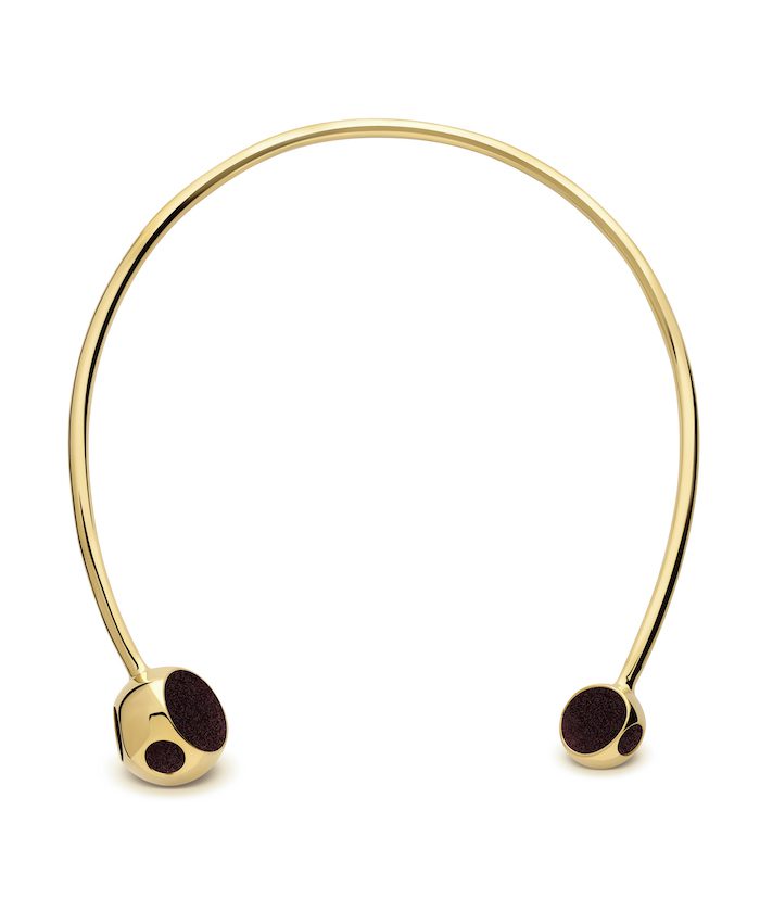 Elegant gold choker with black accents, perfect for stylish outfits.