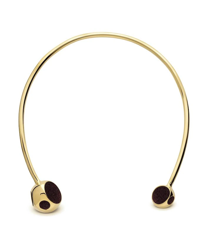 Elegant gold choker with black accents, perfect for stylish outfits.
