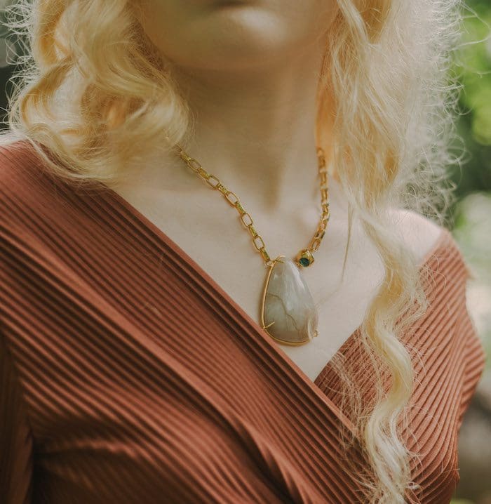 Elegant moonstone pendant with gold square chain, perfect for stylish jewelry lovers.