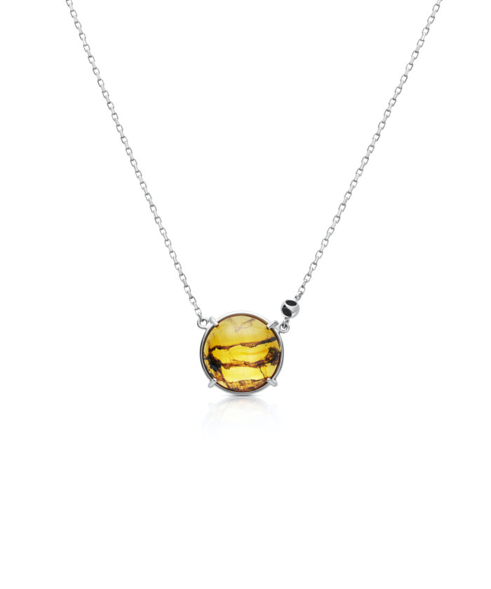 Elegant round amber pendant with silver chain, perfect jewelry for stylish women.