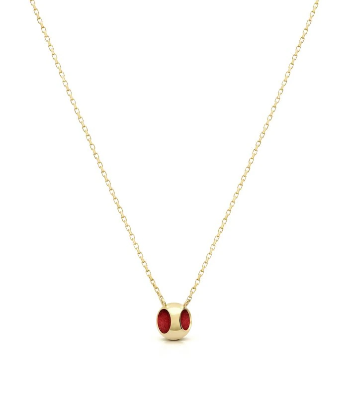 Elegant red enamel pendant on fine gold-tone chain, perfect for sophisticated jewelry styles.