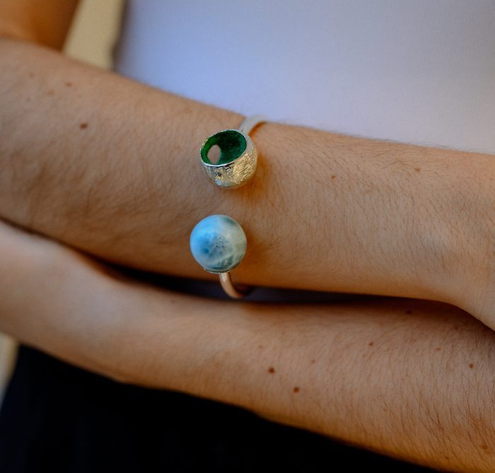 Beautiful larimar sphere jewelry featuring a Larimar bangle on a person's wrist, showcasing elegant natural gemstone design.