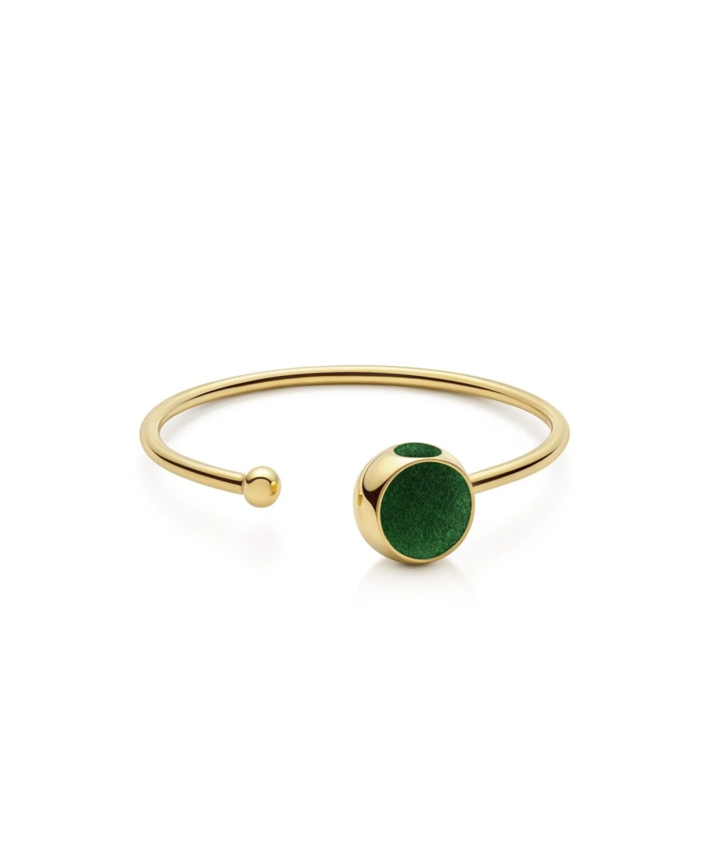 Elegant gold bangle with a green suede or enamel center, perfect for stylish accessories.