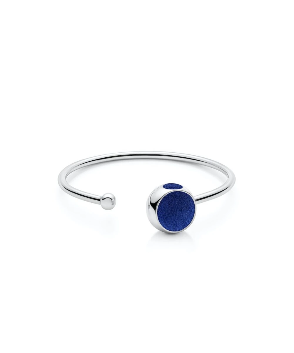Stylish sterling silver bangle with deep blue stone accent, perfect for modern fashion accessories.