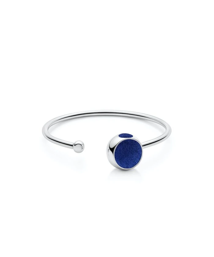 Stylish sterling silver bangle with deep blue stone accent, perfect for modern fashion accessories.