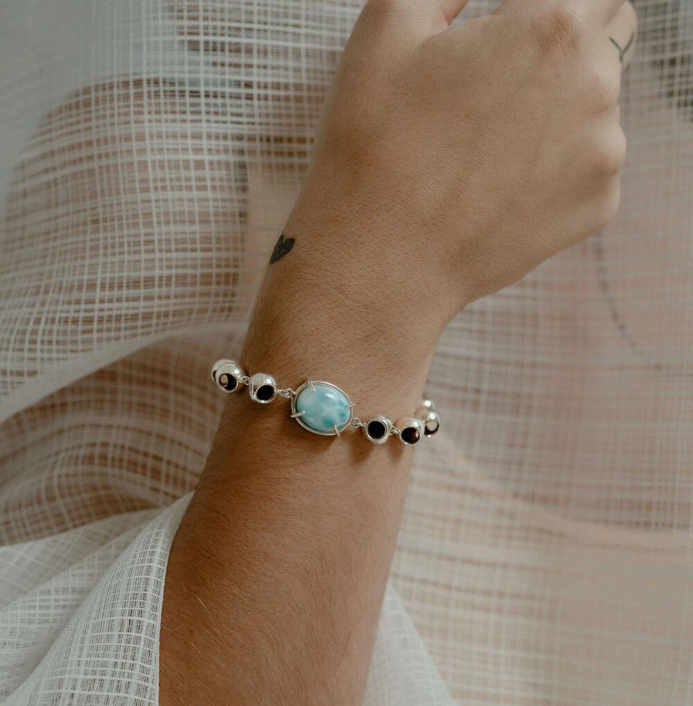 Beautiful larimar infinity bracelet with black and white accents, perfect jewelry for elegant summer styles.
