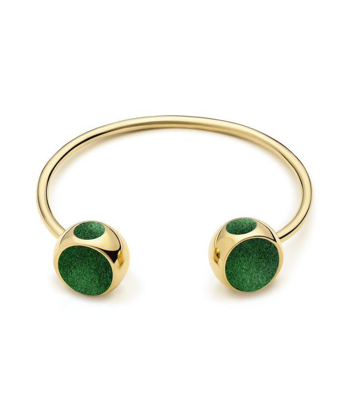 Stylish gold bangle bracelet featuring green accents, perfect for modern jewelry lovers.