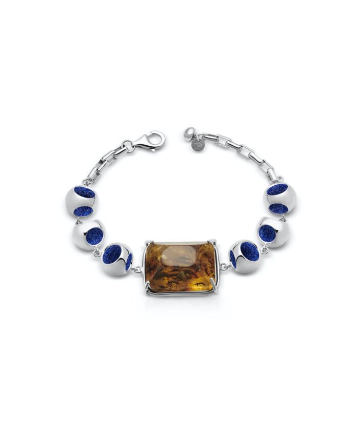 Luxurious silver bracelet with amber centerpiece and deep blue beads for stylish accessories.