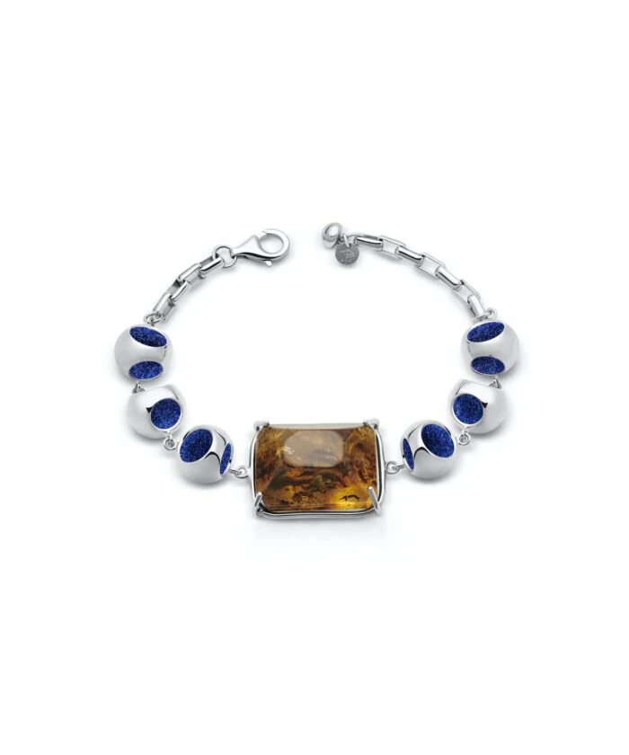 Luxurious silver bracelet with amber centerpiece and deep blue beads for stylish accessories.