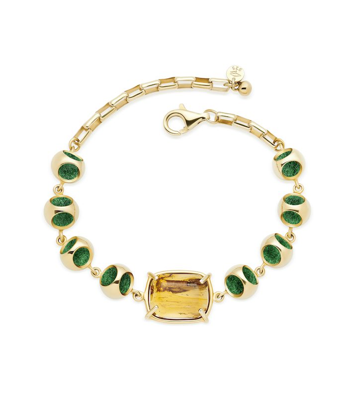 Gold bracelet with amber gemstone centerpiece and green beads, perfect for luxury jewelry collection.