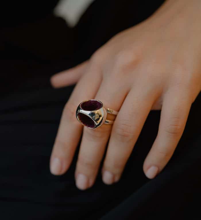 Elegant silver double band ring with deep red gemstone centerpiece for stylish jewelry lovers.