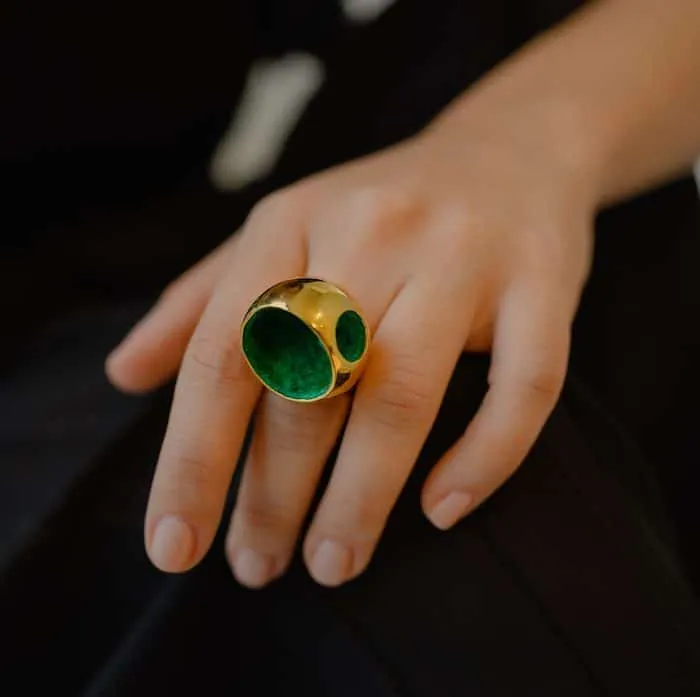 Elegant gold and green statement jewelry ring for special occasions.
