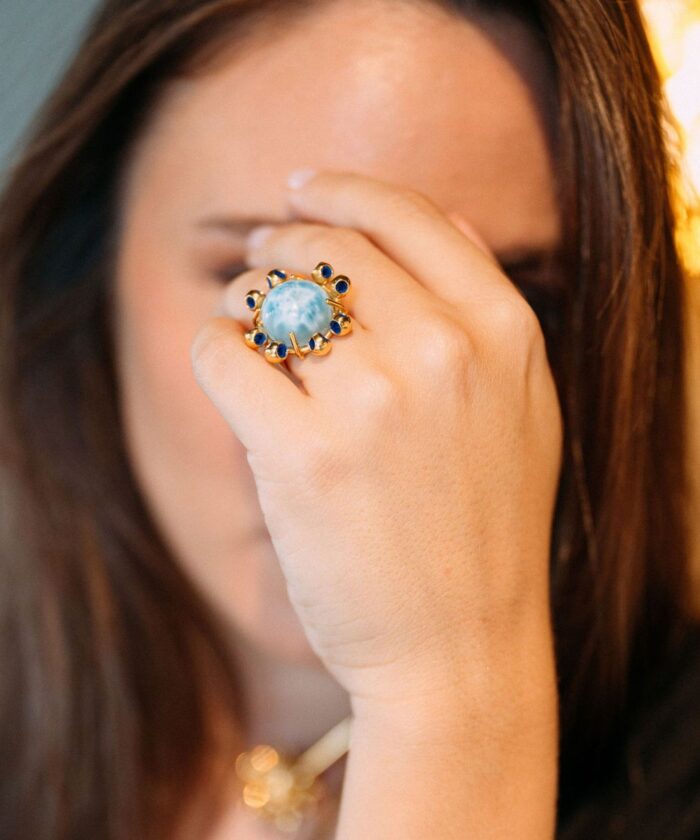 Close-up of Monica Varela ring with a moonstone and navy blue accents.