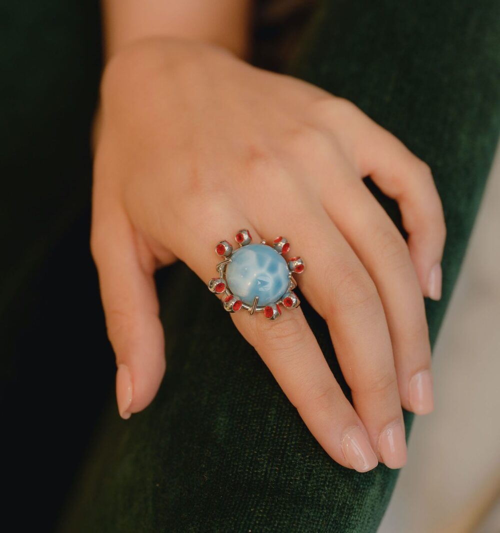 Elegant Larimar ring with red accents, perfect for a unique jewelry statement.