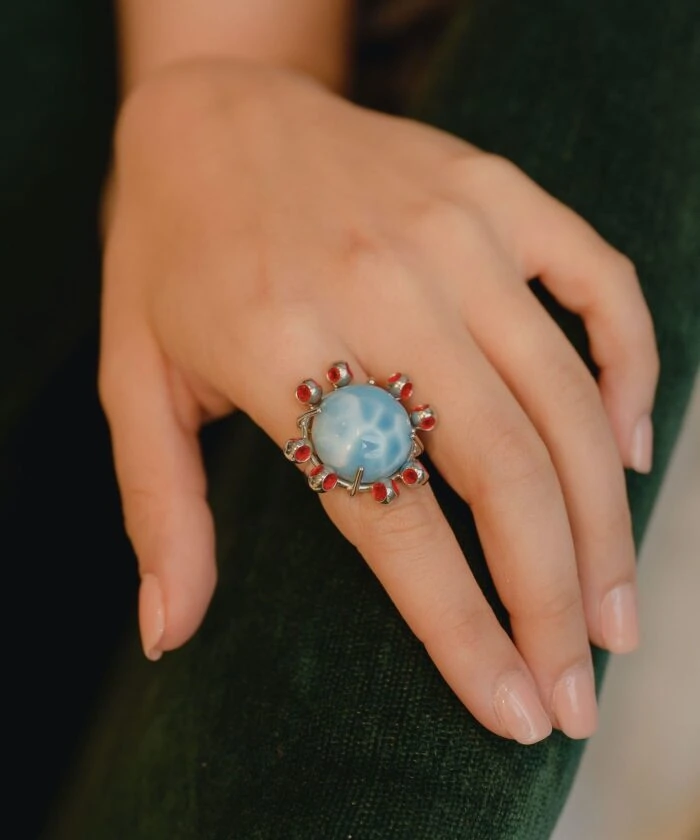 Elegant Larimar ring with red accents, perfect for a unique jewelry statement.