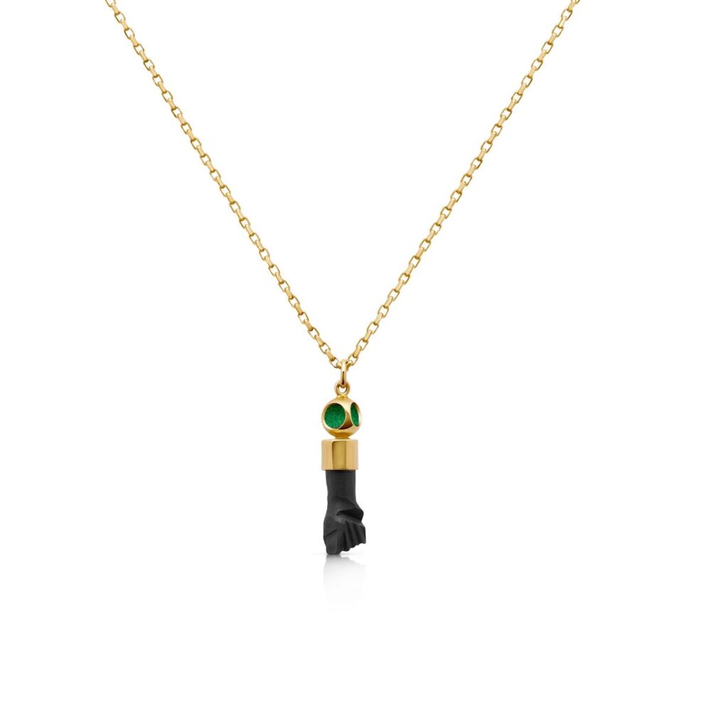 Elegant gold chain necklace featuring a black Azabache bead pendant with green accents.