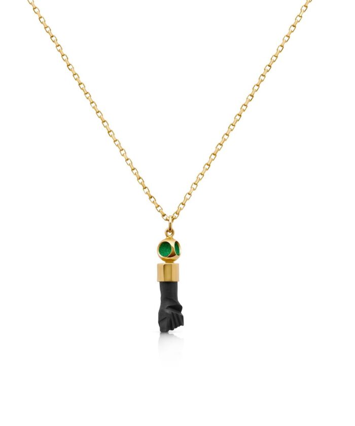 Elegant gold chain necklace featuring a black Azabache bead pendant with green accents.
