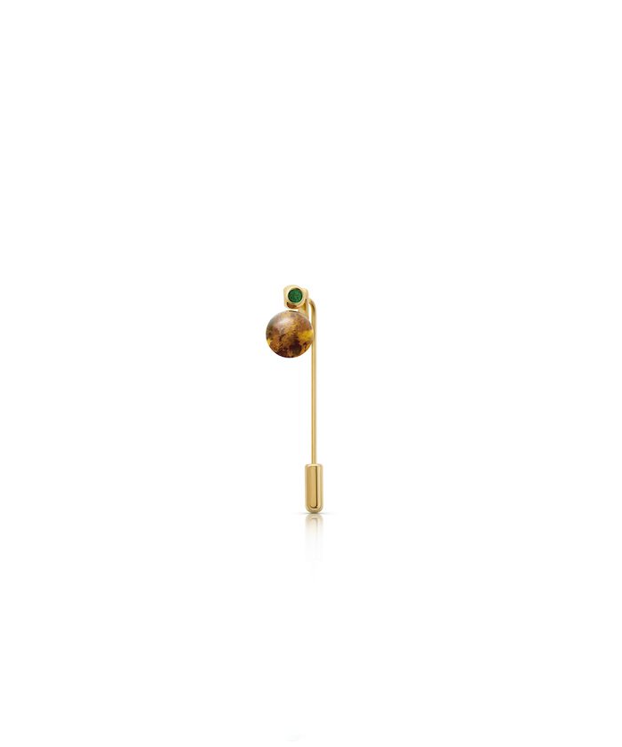 Gold planet lapel pin with green gemstone accent, stylish jewelry accessory.