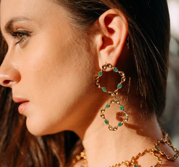 Elegant gold hoop earrings with turquoise stones, perfect for stylish mirror earrings.