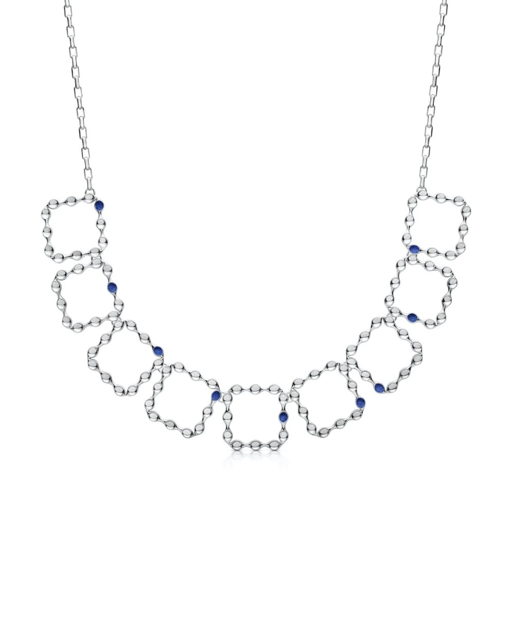 Elegant silver eternity necklace with interconnected hexagonal shapes and blue gemstone accents.