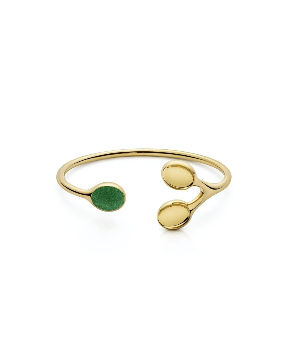 Elegant gold bangle featuring three circular accents, one with green detail for a modern touch.