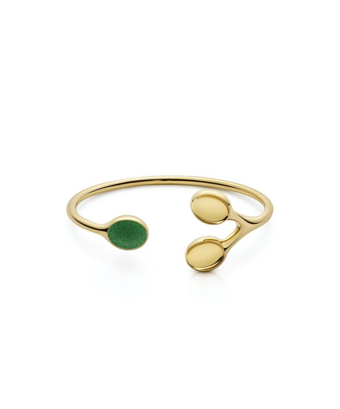 Elegant gold bangle featuring three circular accents, one with green detail for a modern touch.