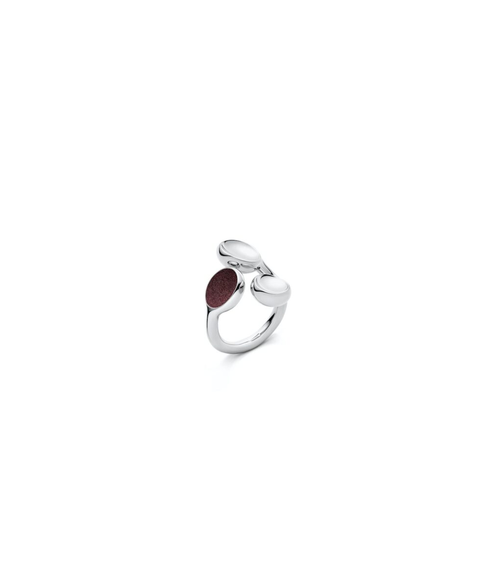 Elegant silver trilogy ring with smooth, rounded design and maroon stone accent.