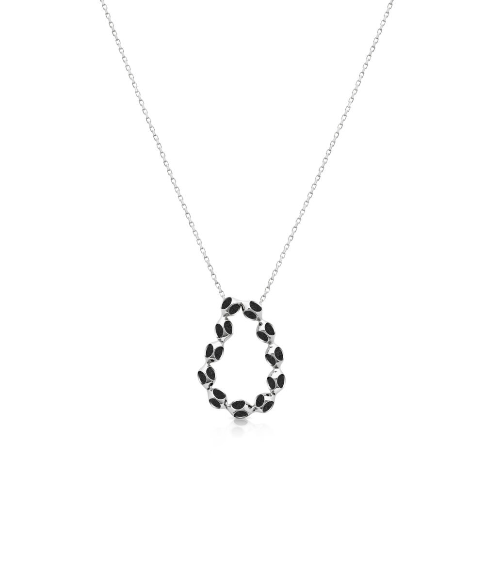 Stylish silver necklace featuring a circular pendant adorned with black details, perfect for modern jewelry lovers.