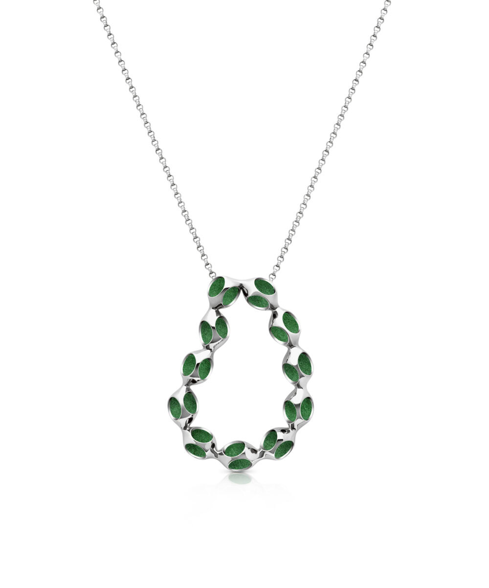 Elegant jewelry featuring a modern silver pendant with vibrant green enamel details.