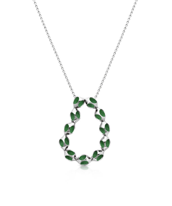 Elegant jewelry featuring a modern silver pendant with vibrant green enamel details.
