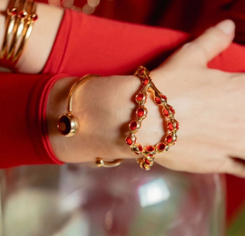 Golden cuff bracelet with red accents, stylish jewelry for women.