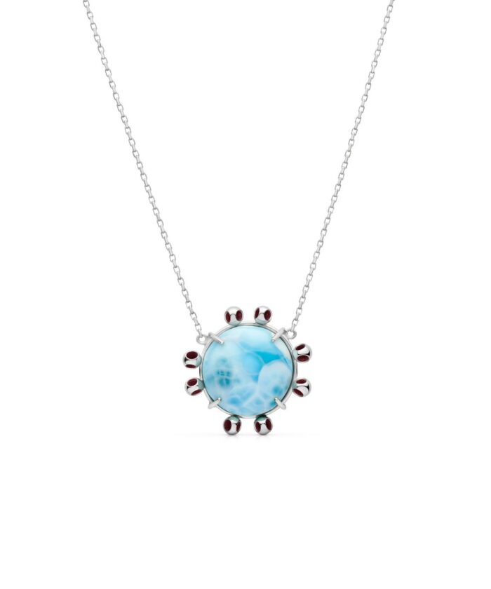 Elegant larimar pendant with silver chain and garnet accents, perfect for beach-inspired jewelry style.