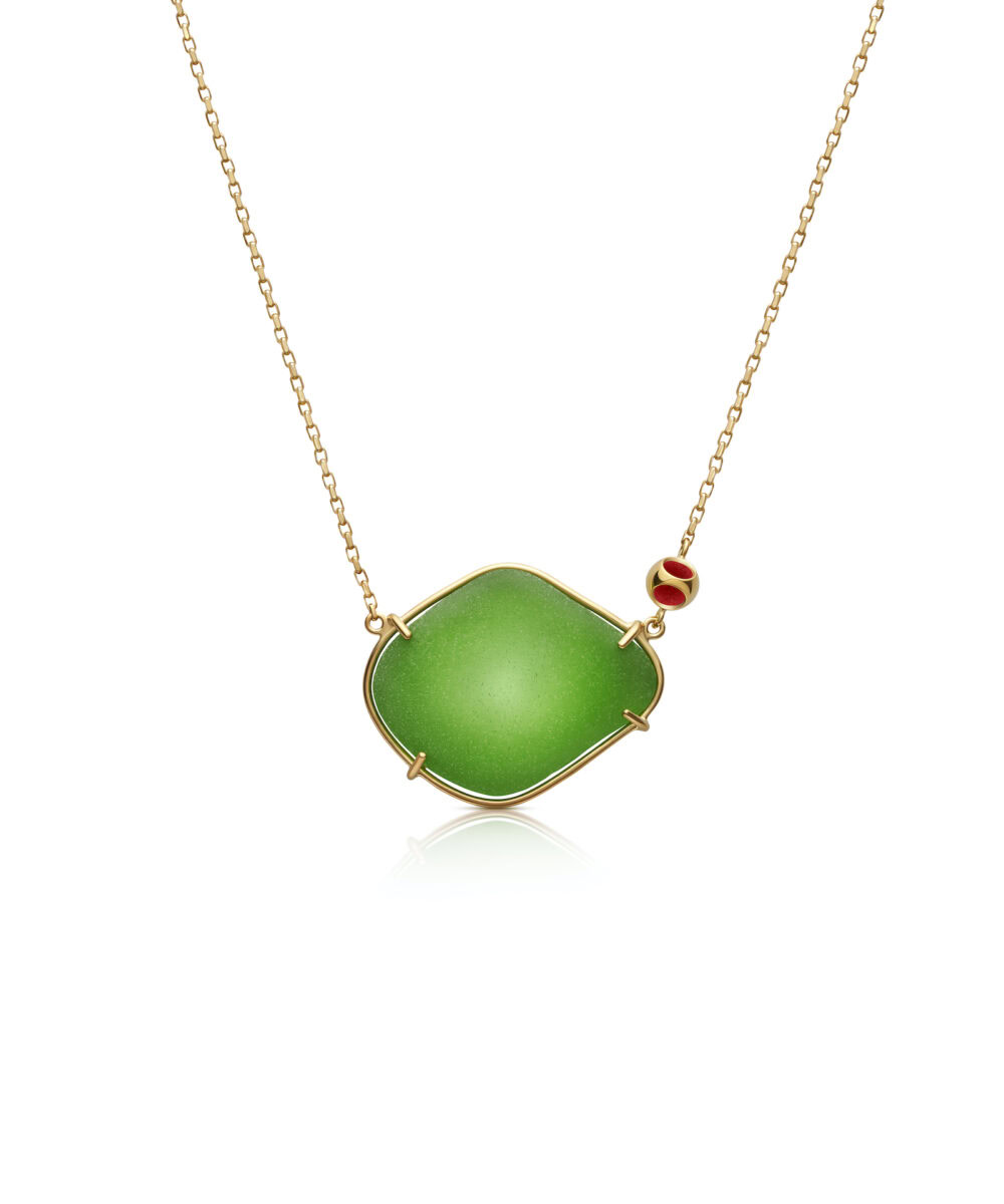Vibrant green sea glass pendant with gold setting on delicate chain. Perfect for coastal jewelry lovers.