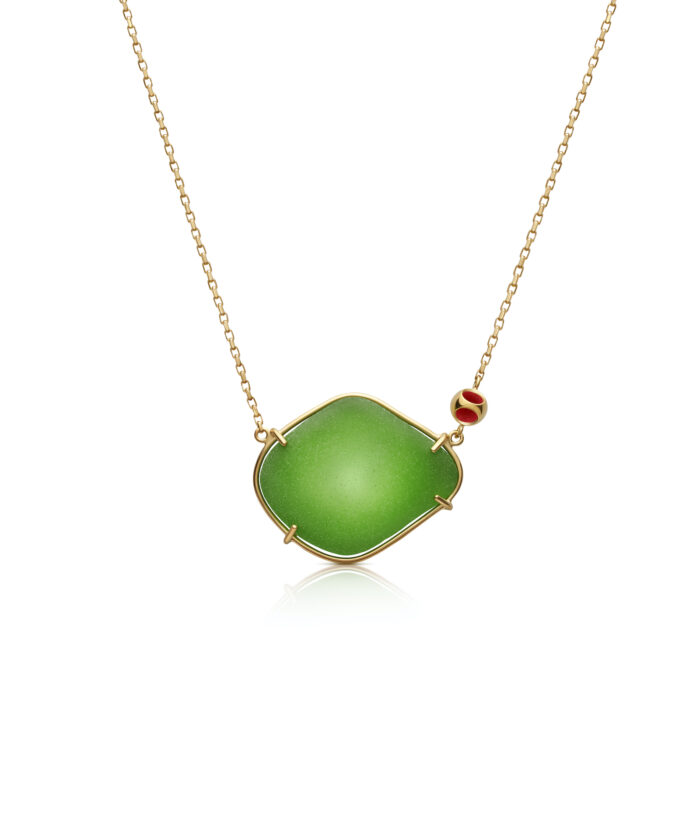 Vibrant green sea glass pendant with gold setting on delicate chain. Perfect for coastal jewelry lovers.