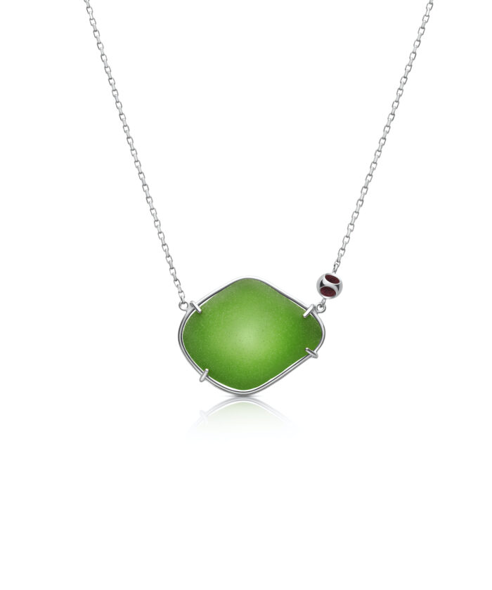Elegant green sea glass pendant on a silver chain, perfect for beach-inspired jewelry.