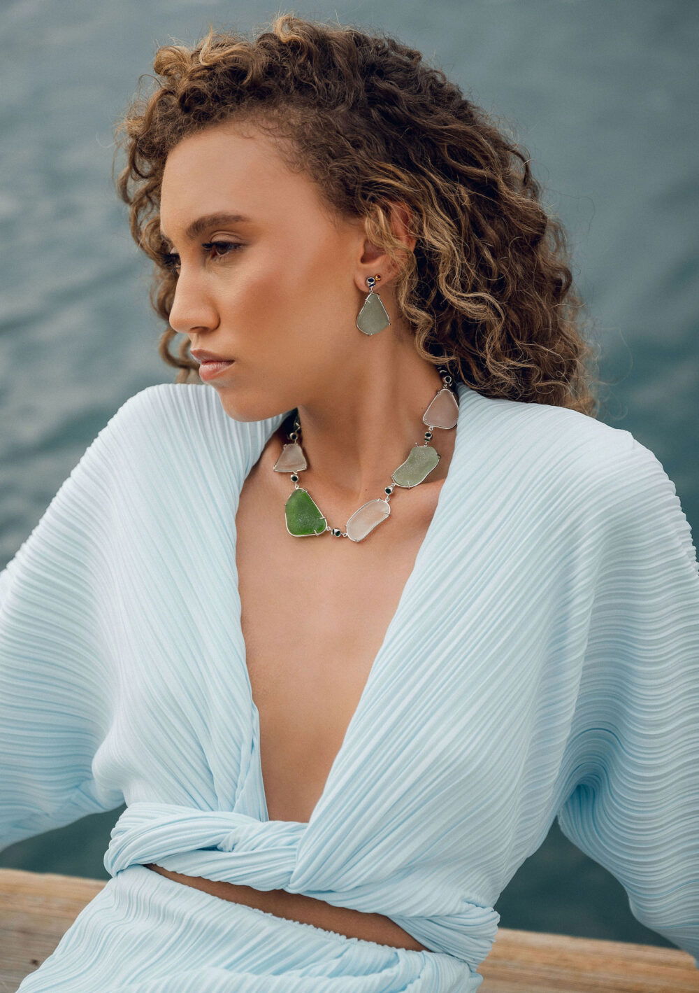 Elegant sea glass jewelry set in varied ocean-inspired shades.