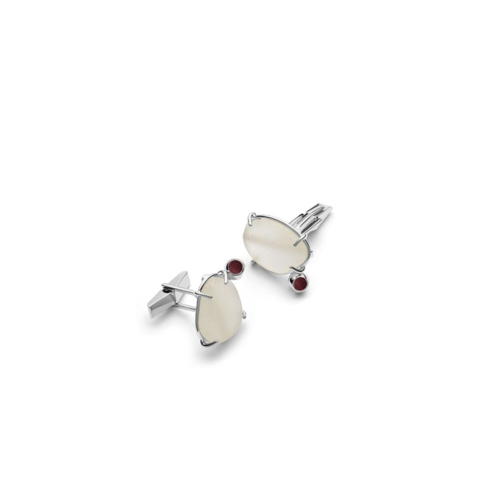 Stylish silver cufflinks with white seaglass accents and red gemstone details.