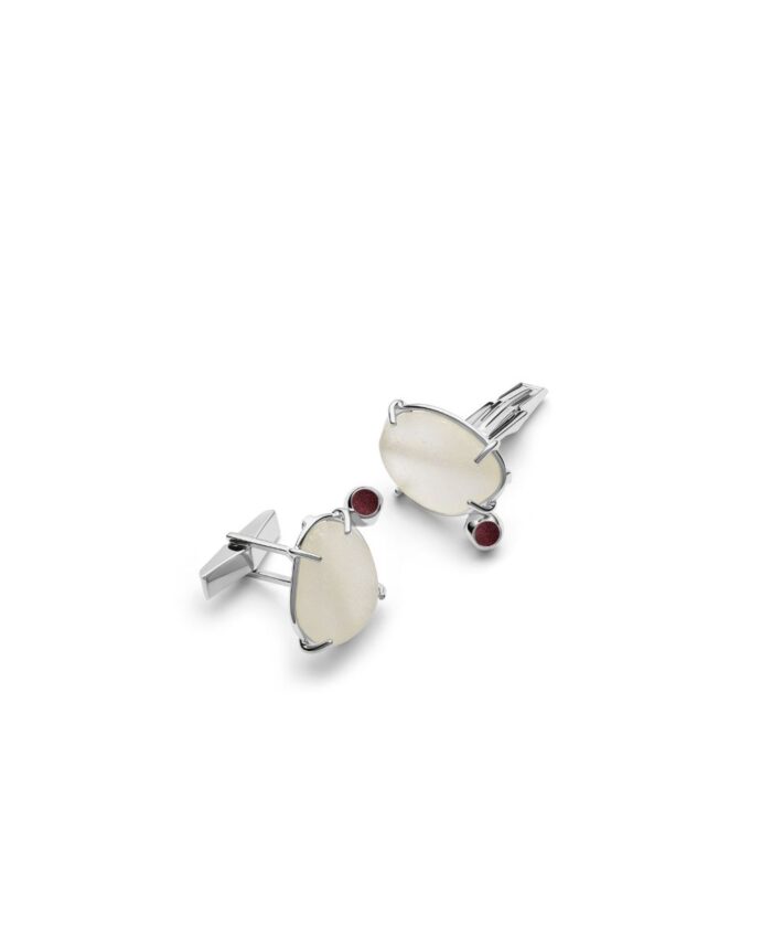 Stylish silver cufflinks with white seaglass accents and red gemstone details.