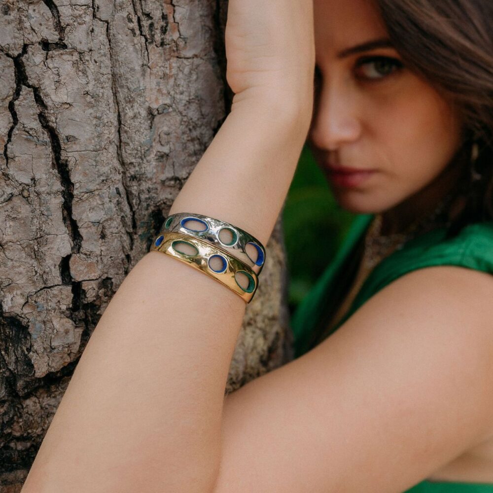 Stylish women wearing colorful open circle jewelry bracelets for fashion and style.