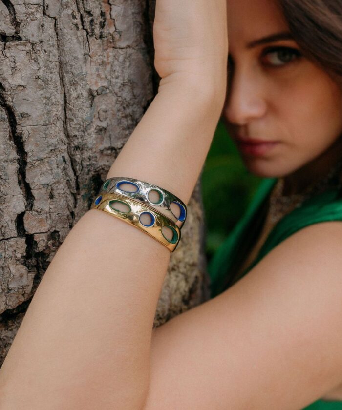 Stylish women wearing colorful open circle jewelry bracelets for fashion and style.