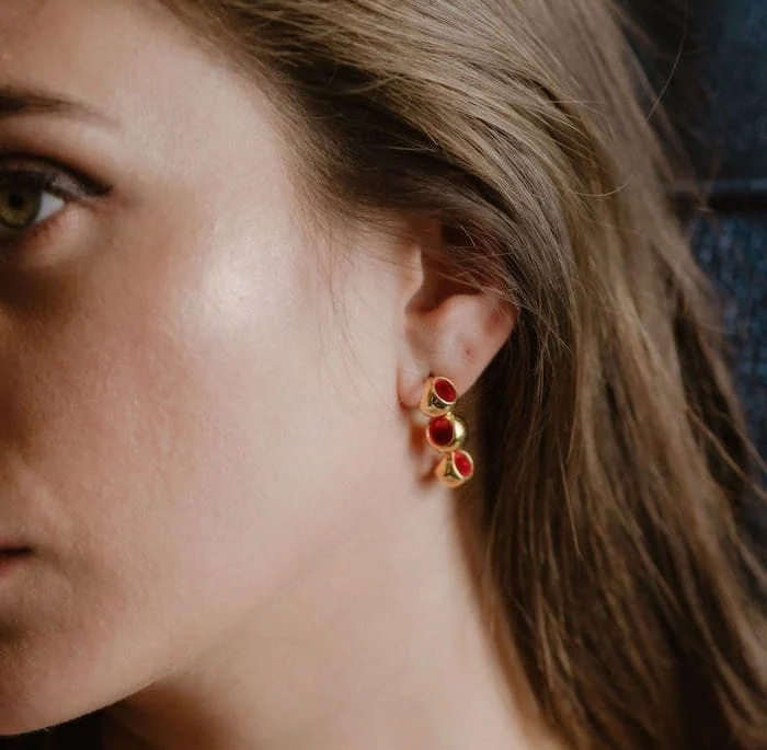 Elegant red and gold dangle earrings for women. Perfect for fashion and special occasions.