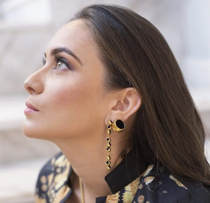 Stylish gold and black dangle earrings perfect for formal occasions.
