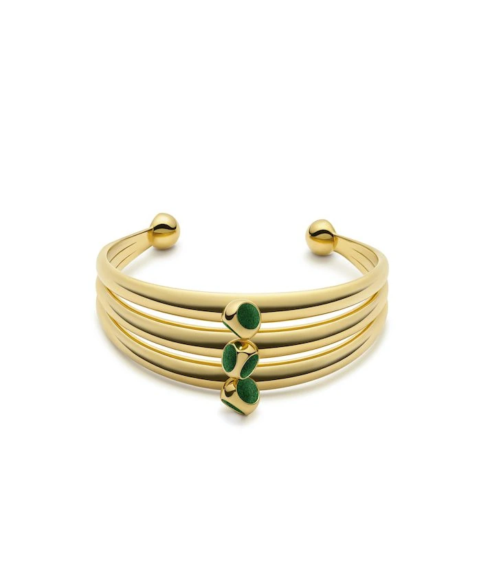 Elegant gold cuff bracelet featuring green oval embellishments for a stylish look.