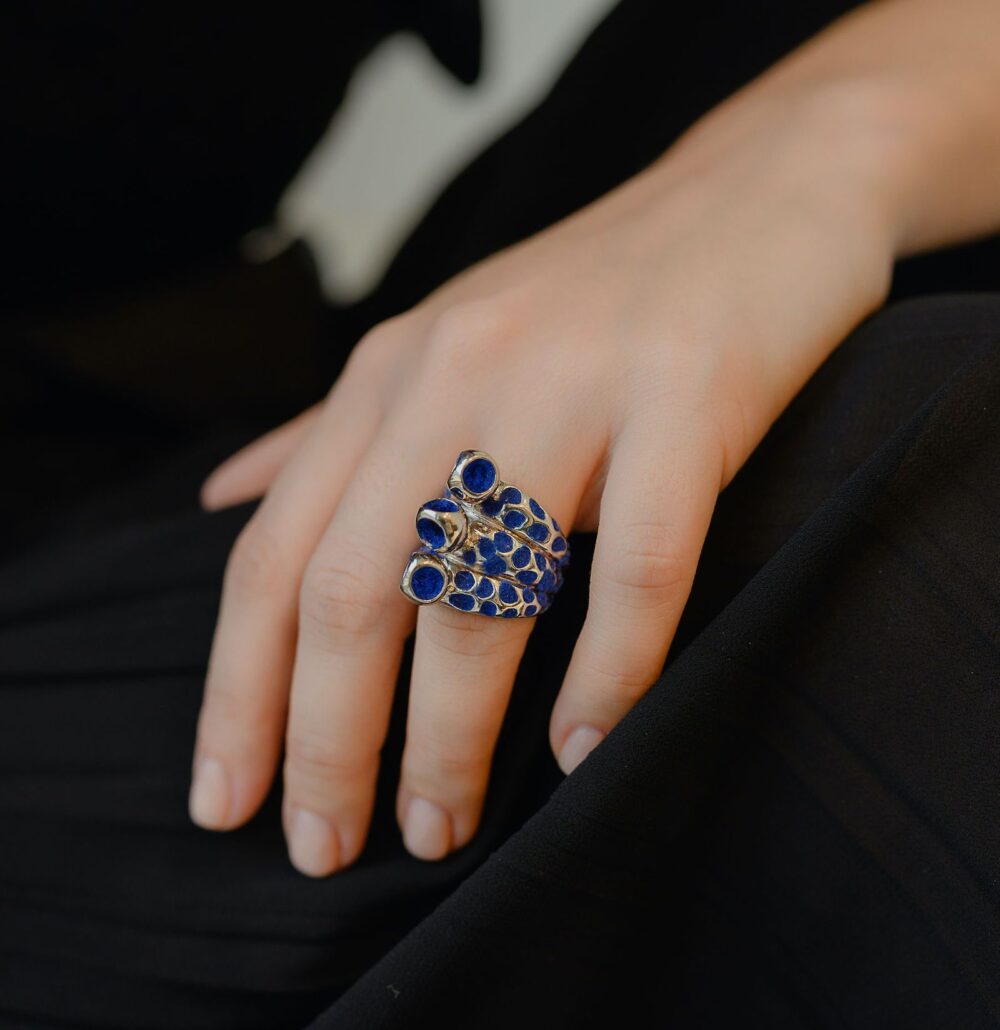 Stylish mosaic trinity ring featuring blue stones and silver details for women.