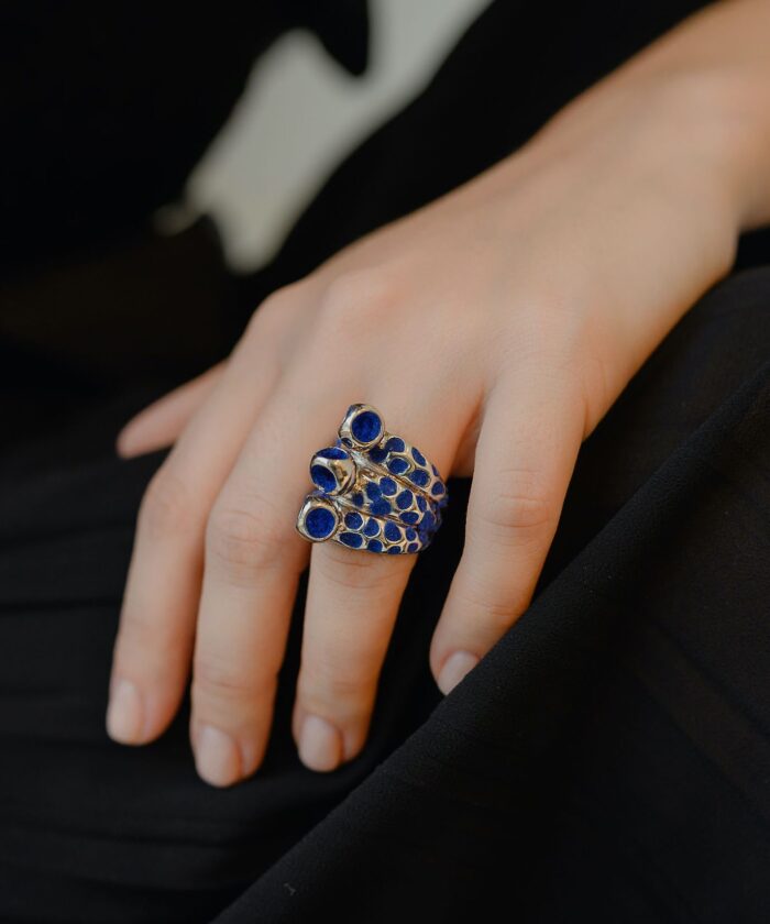 Stylish mosaic trinity ring featuring blue stones and silver details for women.