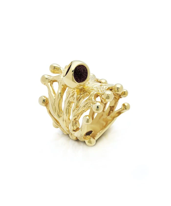 A gold crown-shaped ring with intricate details and round accents, exuding luxury and elegance.
