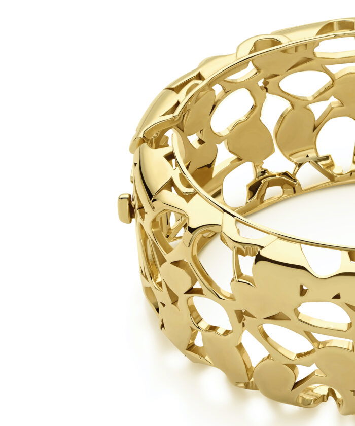 Gorgeous gold heritage bangle with intricate openwork design, perfect for stylish accessories.